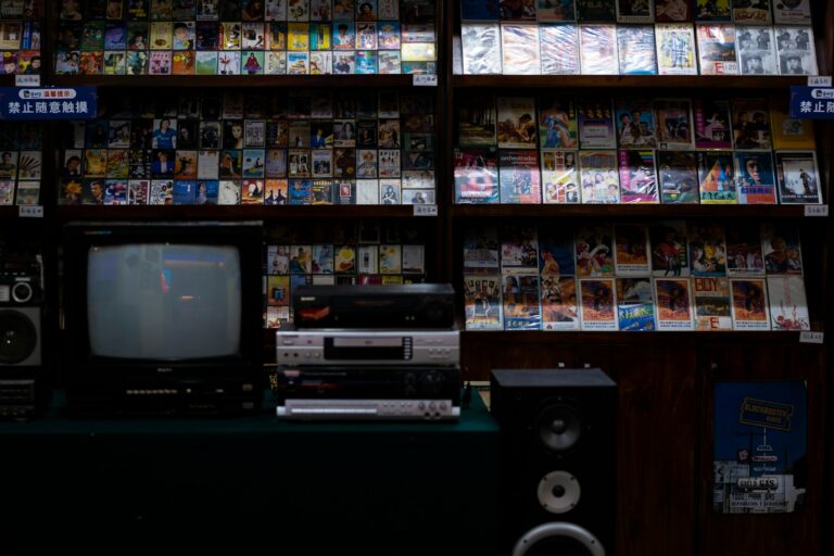 a television sitting on top of a table in front of a book shelf