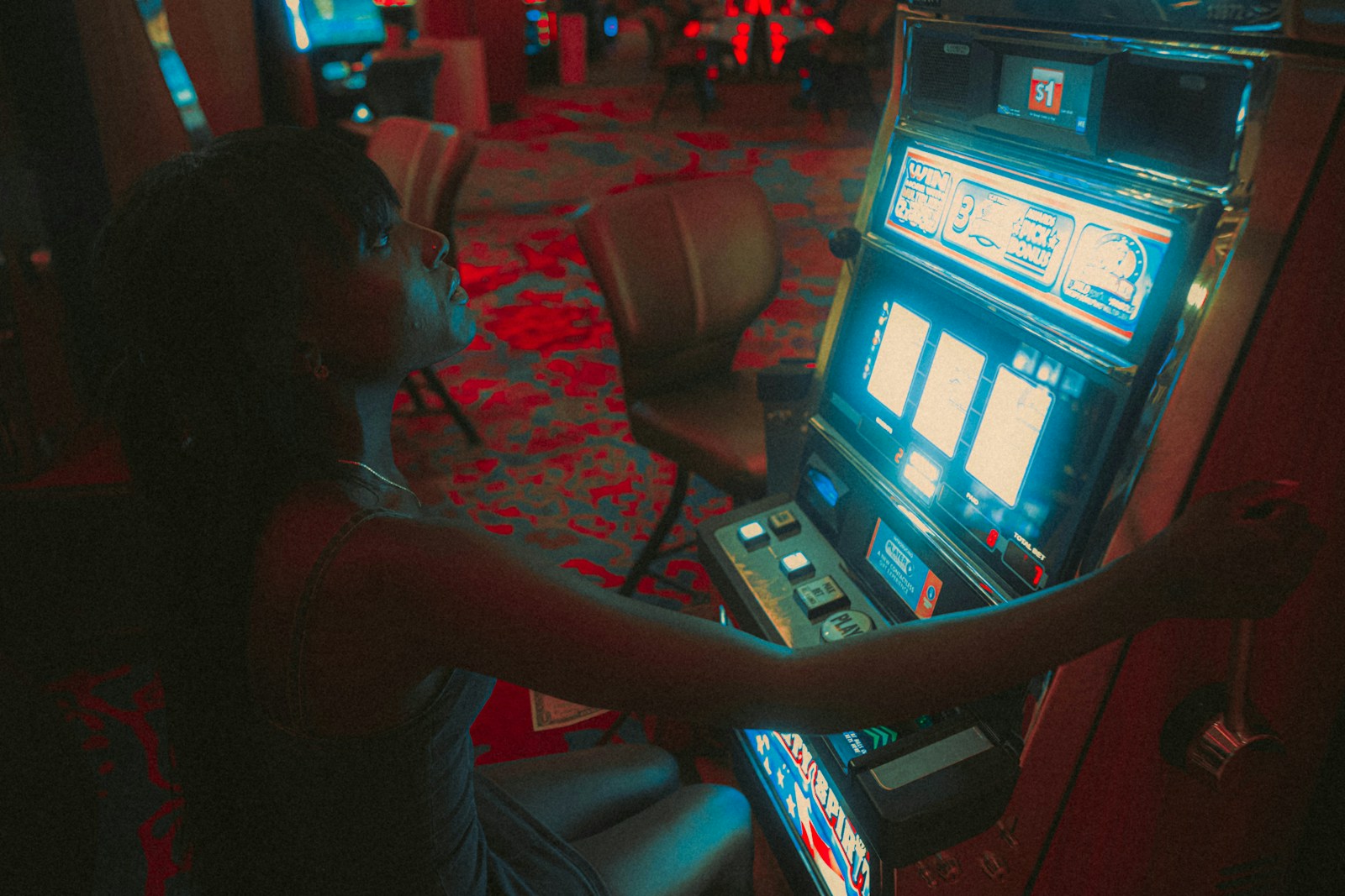 a woman playing a slot machine in a casino